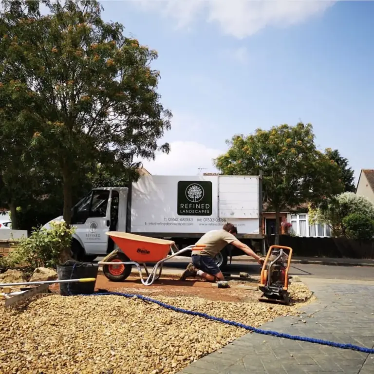 Jacob Berry in the early days of Refined Landscapes: the first van, a wheelbarrow and a plate compactor on a gravel drive