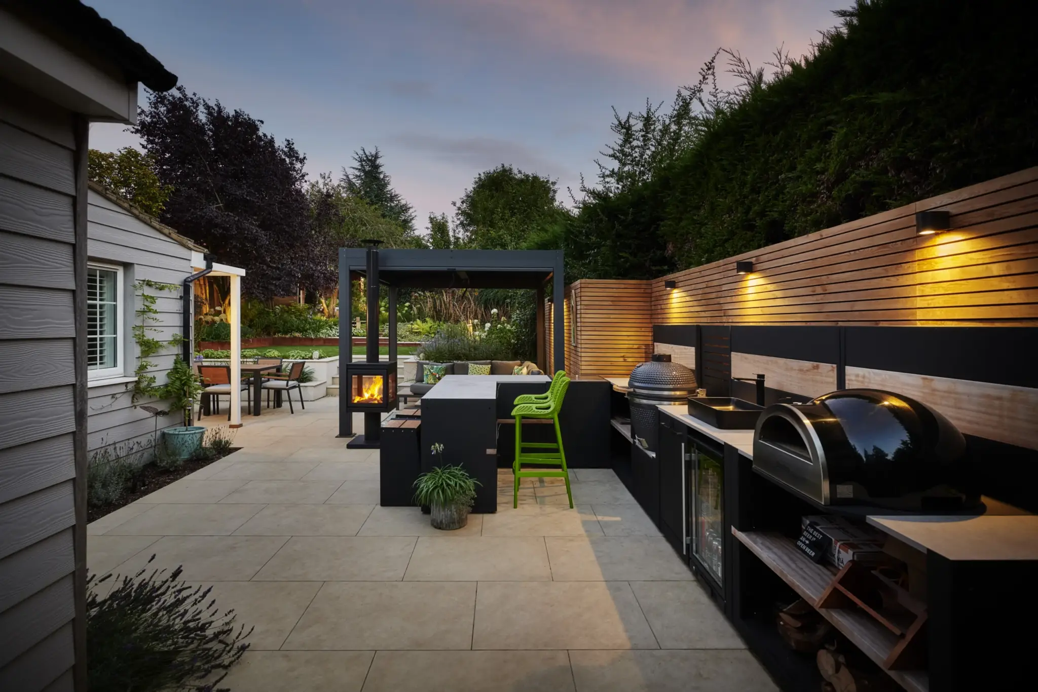 Outdoor kitchen, lighting and terrace within a wider Refined Landscapes garden