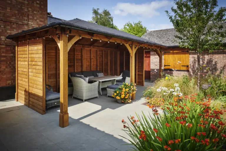 A pergola providing shade and shelter in a Refined Landscapes garden