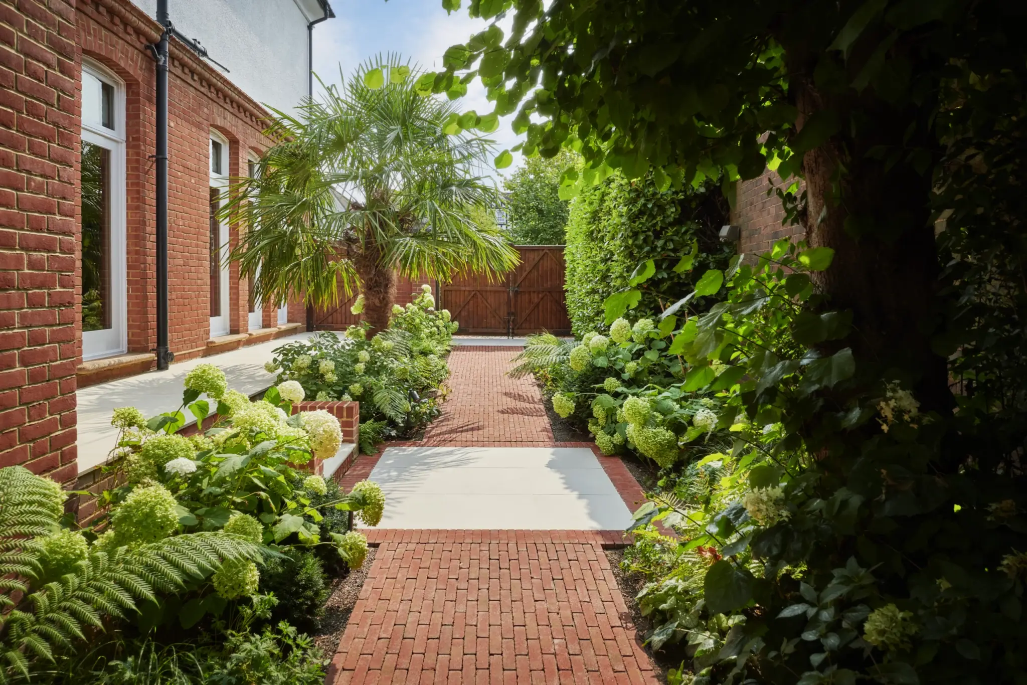 Lush established planting connected to the property in a Refined garden
