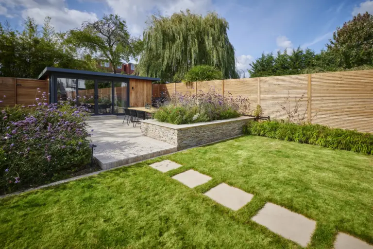 Garden room and connected outdoor space by Refined Landscapes