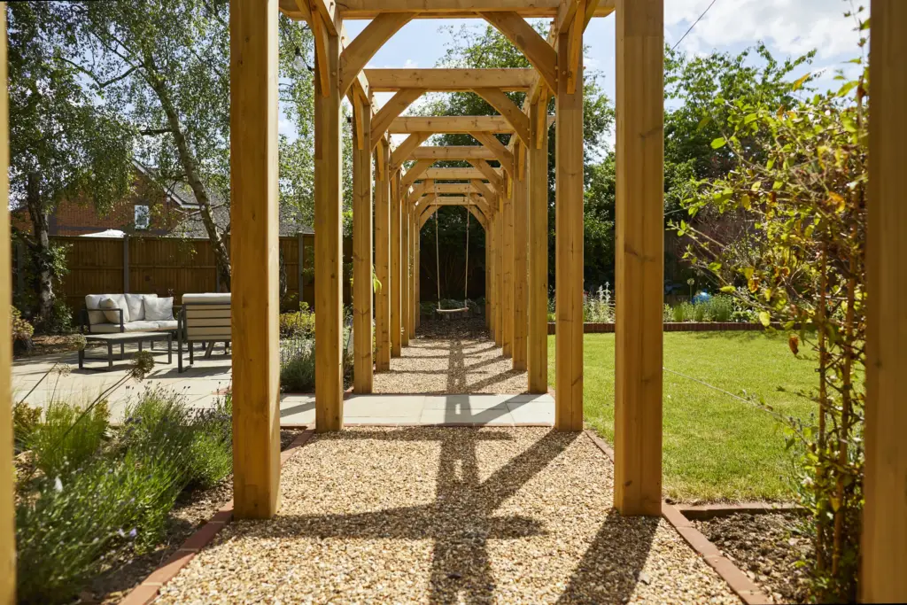 Looking through the oak archway pergola towards the lawn