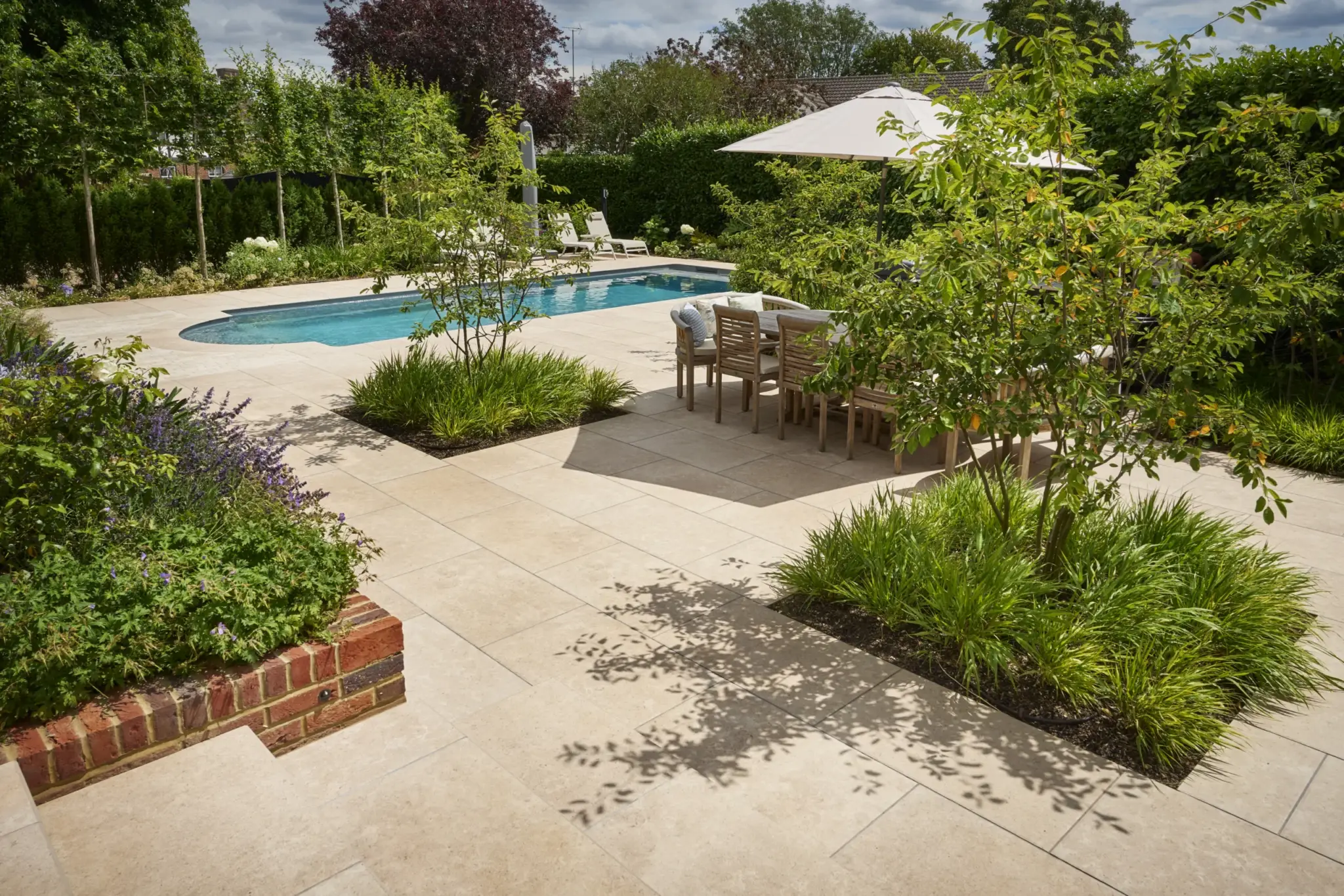 Completed Refined Landscapes garden terrace with evening lighting