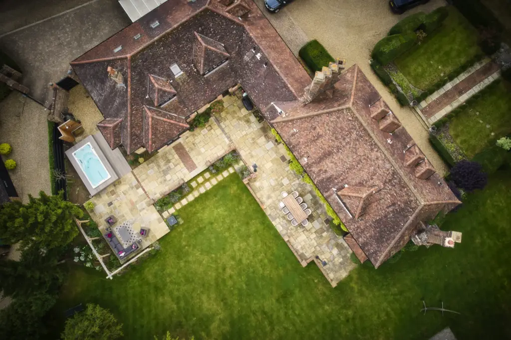 Aerial view of the house, terraces, swim spa and oak gazebo set in the lawn