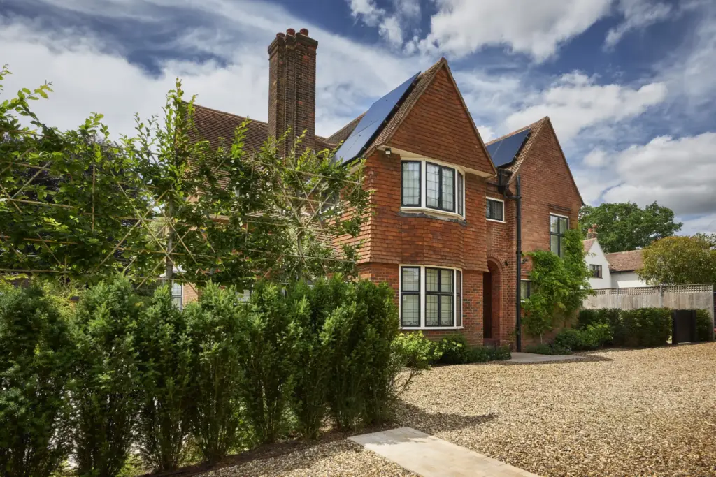 The arrival: the gravel drive and pleached trees along the side of the house
