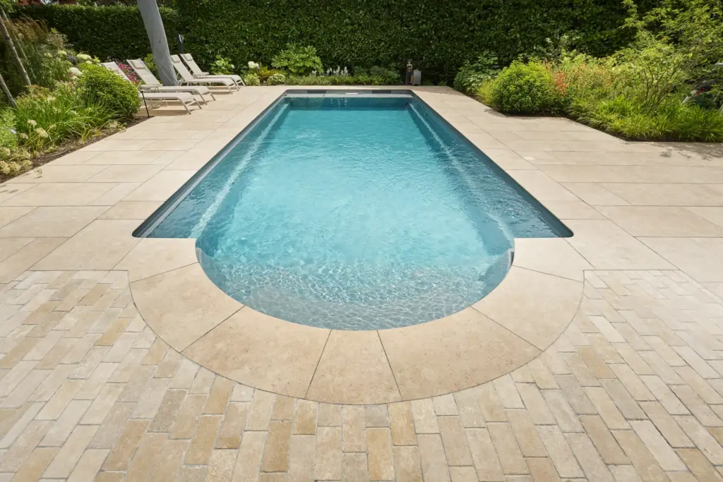 The Roman-end swimming pool set into its limestone cobble surround