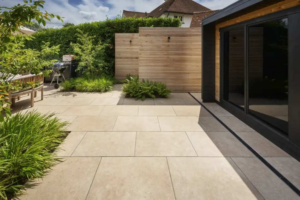 The sauna and changing room unit on the limestone terrace, with planting against the boundary