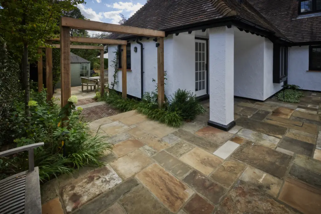 Traditional garden with natural stone paving and considered construction detail