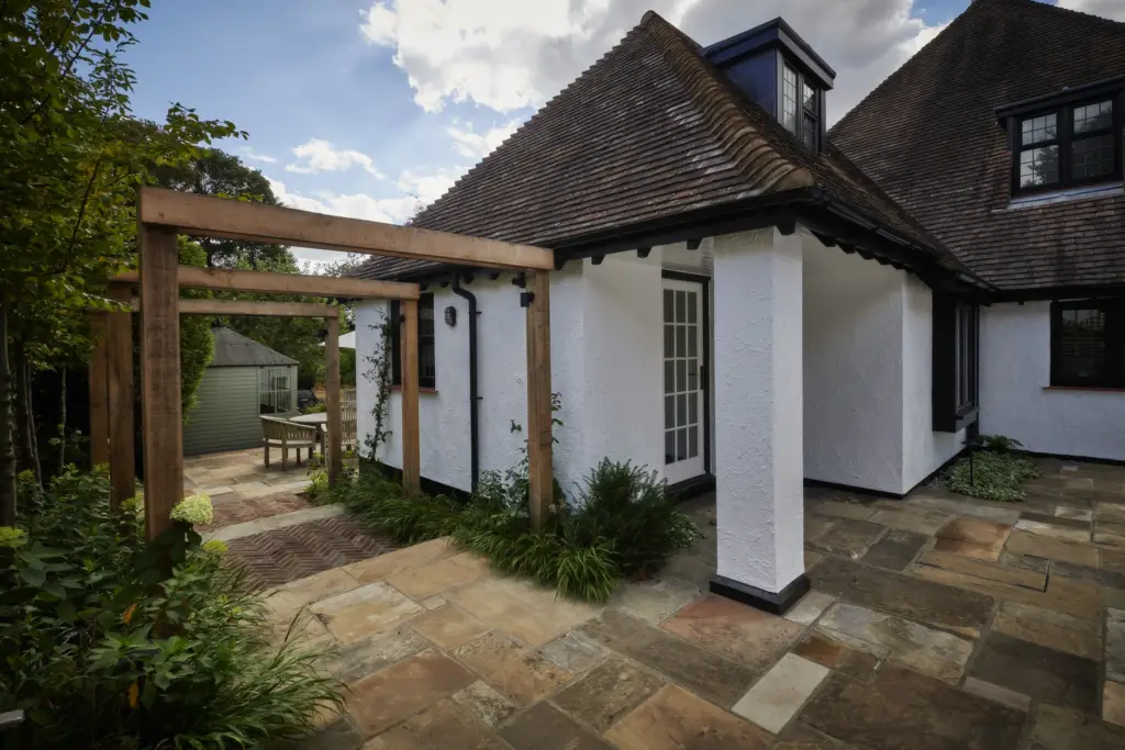 The courtyard terrace with the oak pergola and the house beyond